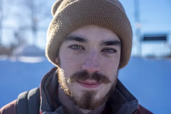 Close-up of Michael in a tan toque, in winter